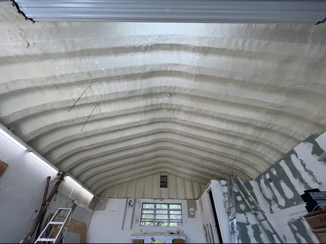 Spray polyurethane foam applied to the underside of a metal roof deck in Edgewater